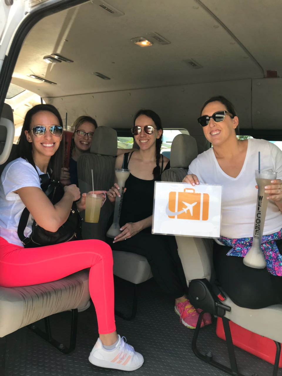 Group of four women enjoying drinks aboard the vehicle